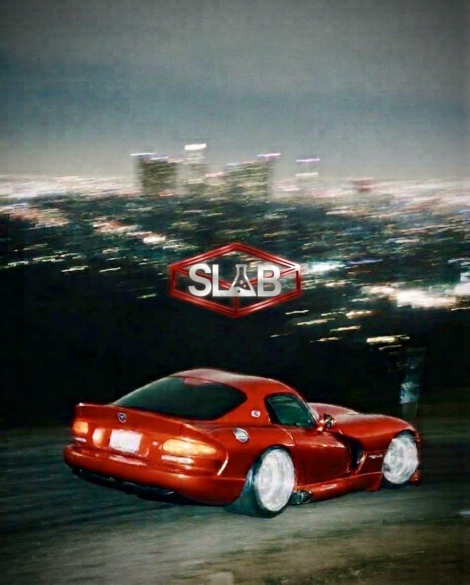 SLAB logo over a red sports car above the city